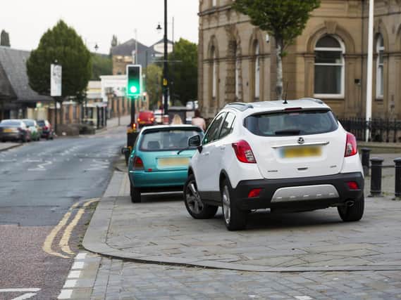 Cars parked on the pavement in Batley town centre