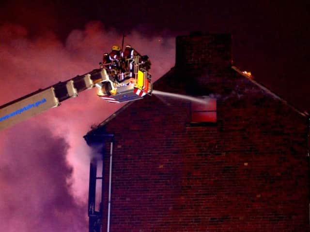 Firefighters tackle a blaze at a house on Prospect View, off Pinfold Hill, Dewsbury in February 2013