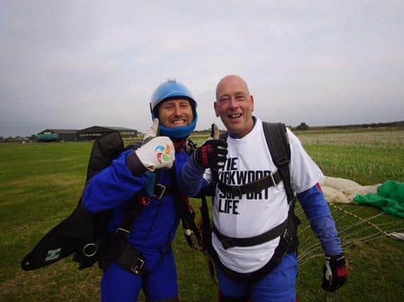 Mr Eastwood and his instructor give the thumbs up after completing the jump. Photo: Hibaldstow Skydive