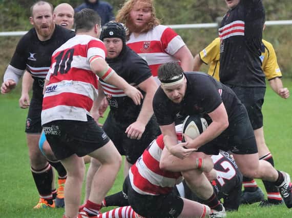 Old Brodleians' Elliot Craven is all wrapped up by Cleckheaton tacklers. Picture: Robin Sugden