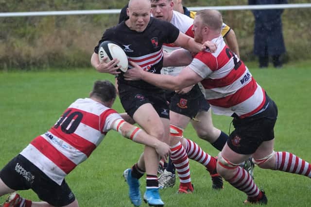 Old Brodleians' Jimmy Hodkinson takes some stopping on a determined burst against Cleckheaton. Picture: Robin Sugden
