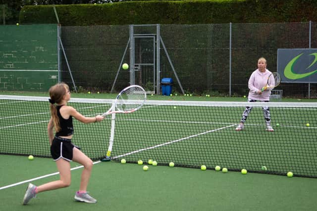 Coach Elena Zagrebina leads a training session with young players at Liversedge Tennis Club