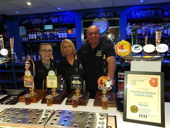 Peter and Joanne Jagger with head barperson Hannah Croft celebrate their Club of the Year award from the Heavy Woollen Branch of CAMRA.