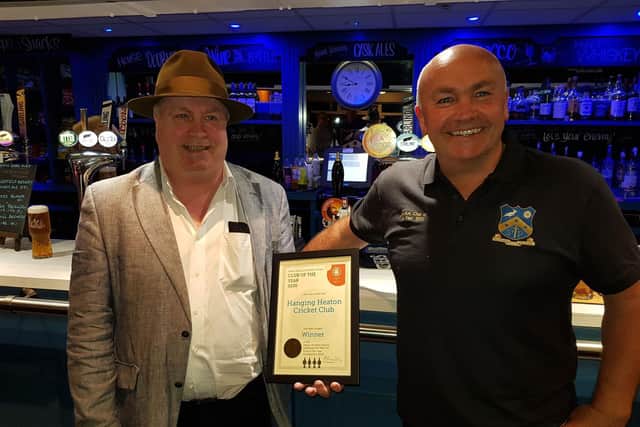 Mike Roebuck, chairman of the Heavy Woollen Branch of CAMRA, presents the group's Club of the Year award to club steward Peter Jagger at Hanging Heaton Cricket Club