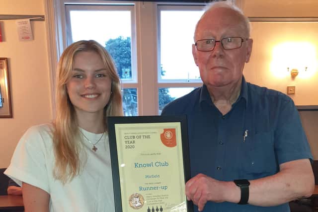 Heavy Woollen CAMRA branch committee member Mike Church presents a certificate to Hannah Smurthwaite at Knowl Club, Mirfield, runner-up in the branch's Club of the Year 2020