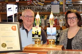 Derek Robinson, chairman of Thornhill Cricket and Bowling Club, and barperson Lauren Kaye receive the Heavy Woollen Branch of CAMRA's Club of the Season Award for Winter 2019/20, which was delayed due to the pandemic