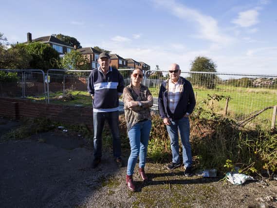 Land next to Hanging Heaton Working Men's Club and behind houses on High Street, where there are plans to build houses. Residents, from the left, Stephen Crossley, Sarah Gomersall and Derek Crossley are objecting to the plans
