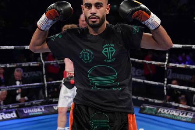 Amaar Akbar raises his hands after a good performance in his second professional fight.