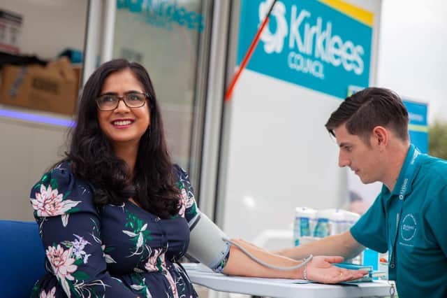 Councillor Musarrat Khan, Kirklees Council's cabinet member for health and social care, undergoing a health check with a qualified wellness coach