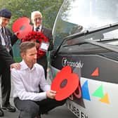 Team Pennine buses in Calderdale and Kirklees are being adorned with poppies to support the annual Poppy Appeal, as the nation prepares to remember the fallen. From left, veterans Geoff Lister, Michael Scott and Keith Webster watch as engineer Jonathan Ruston fits a poppy to one of the company’s buses