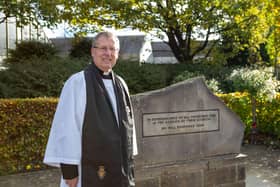 Rev Simon Cash, Team Rector at Dewsbury Minster, at the war memorial on Longcauseway
