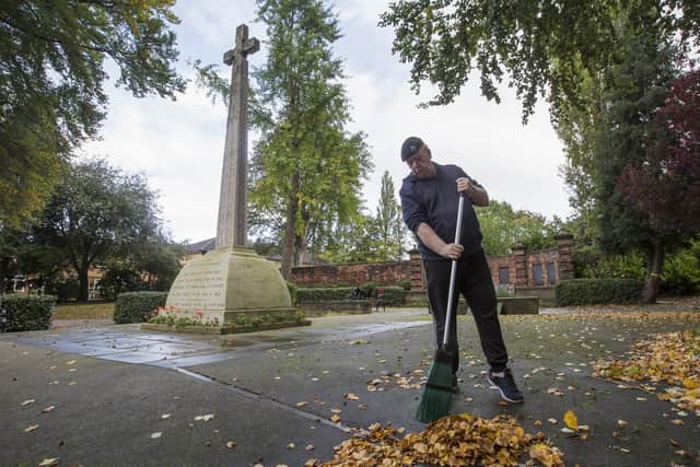 Tim sweeping leaves in Ings Grove Park to prepare the town's war memorial for the Remembrance commemorations