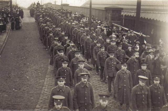 A sombre procession of fellow soldiers march in front of the funeral cortege from Thornhill Lees, of John James Tighe, who died from his wounds in  January, 1915. Requiem Mass at St Paulinus Church was followed by burial at Dewsbury Cemetery. The procession can be seen crossing over Savile Bridge.