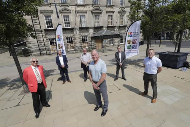 Former Huddersfield Giants coach and England player Malcolm Reilly (centre front) with from left: Tim Adams, chairman of Rugby League Cares; leader of Kirklees Council, Coun Shabir Pandor; trustee of Rugby League Cares, David Hinchliffe; Professor Tony Collins, rugby league academic; and Chris Rostron, head of Rugby League Cares, outside the George Hotel in Huddersfield