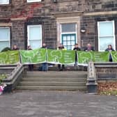 Transformers North pictured holding 10 years’ worth of Green Flags in Crow Nest Park, Dewsbury
