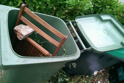 A green bin in Kirklees containing non-recyclable waste