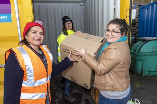 Coun Naheed Mather (left) and Kirklees Council project manager Rachel Palmer (centre) help Moldgreen resident Costandia Demetriou load her items at one of the new reuse sites recently opened by the council