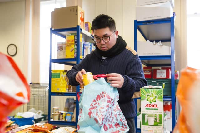 Volunteer Leo Chan packs a food parcel at Batley Food Bank