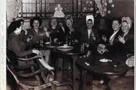 SMILES AND LAUGHTER: Workers from Mark Oldroyd’s Mill enjoying a traditional Christmas Eve drink in the Great Northern pub