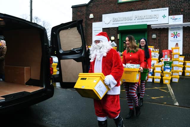 Santa and his elves load up the van ready for delivery