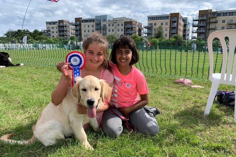 Eastbourne Armed Forces Day. Lucia and Sophia with Betty the golden retriever. Betty was runner up in the category of dog the judge would most like to take home at the event's dog show. Picture by Matt Hunt. SUS-210628-122733001