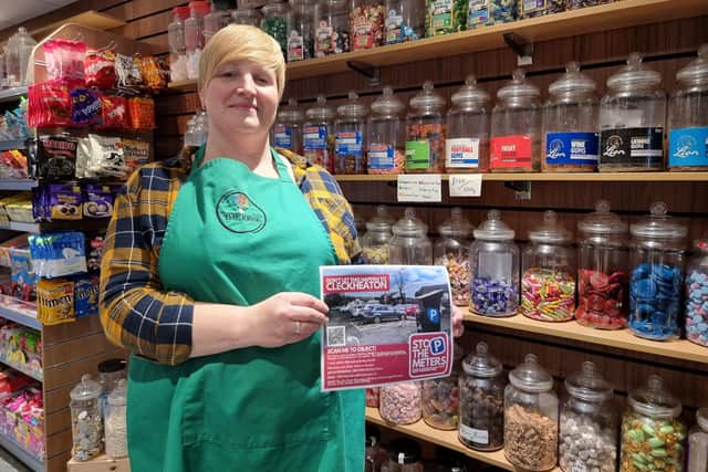 Faye Doherty, who owns both The Kiosk and Marshalls Coffee House and Bakery in Victoria Court, with a Stop The Metres poster, which are being put up around the town.