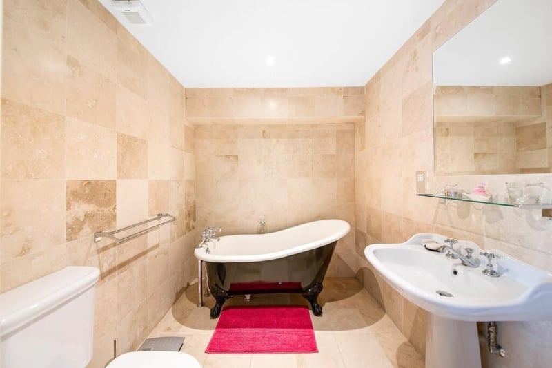 An en suite with a free-standing bath tub.