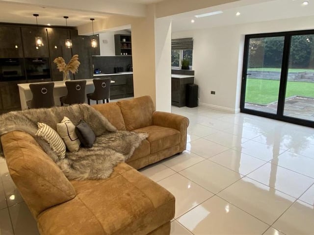 The glossy open plan interior with doors to allow indoor to outdoor living in the warmer months.