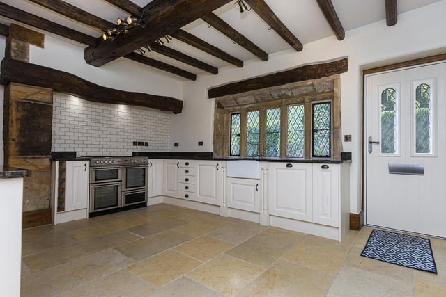 Dating back to the seventeenth century, the kitchen has exposed beams and lintels, with timber fitted units and granite worktops.