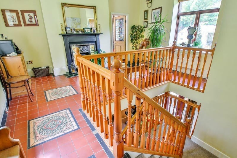 A gallery landing with tiled floor and feature fireplace on the first floor.