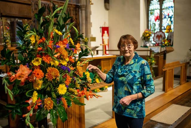 Linda Hutchinson waters the flowers, St.John's Church in Upper Hopton.