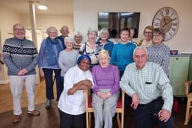 Marjorie Hirst, centre, celebrates her 103rd birthday at Roberttown Care Home along with her son Graham, right, staff, and friends from Trinity Church's choir.