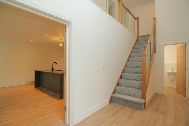 The hallway and staircase with glass balustrade.