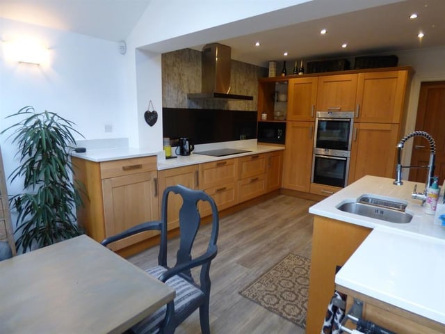 The well equipped dining kitchen has fitted units with integrated appliances.