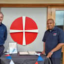 Adrian Roberts (left), Pastor of Zion Baptist Church and Deacon Al Henry, Minister of Saint Andrew's and Trinity Methodist churches, next to the book of condolence outside Saint Andrews