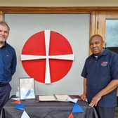 Adrian Roberts (left), Pastor of Zion Baptist Church and Deacon Al Henry, Minister of Saint Andrew's and Trinity Methodist churches, next to the book of condolence outside Saint Andrews