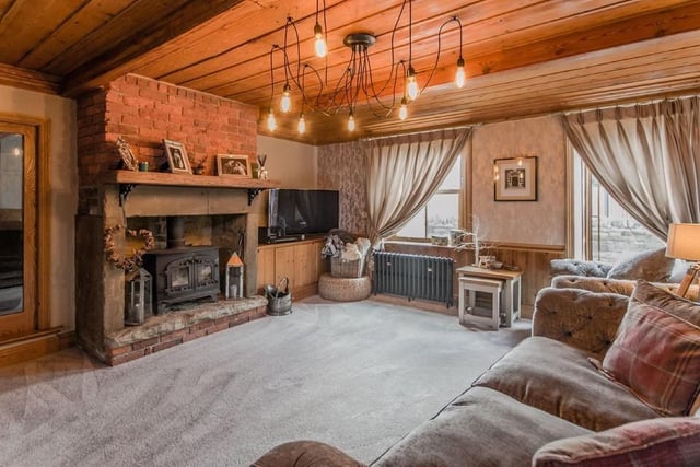 The fireplace is a focal point of the lounge, with wood burning stove.