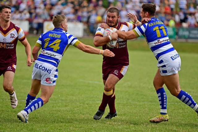Batley's James Brown in a tussle with Halifax's Ben Kavanagh and Kyle Wood