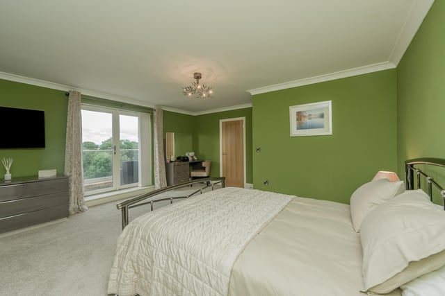 The main bedroom has French doors out to a balcony with glass balustrade.