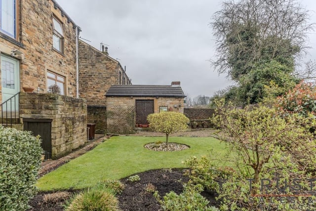 To the rear of the house is a quiet and private lawned garden with additional seating areas.