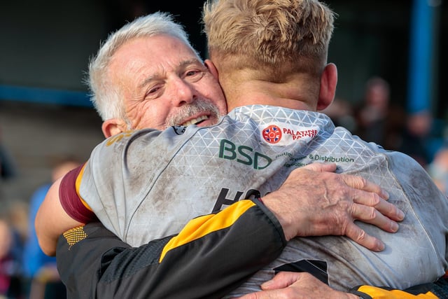 Proud conditioning coach Paul Royston hugs Luke Hooley after the game. Picture: Neville Wright