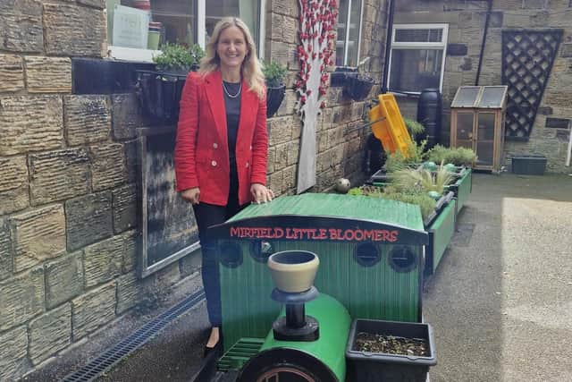 Kim Leadbeater, MP for Spen Valley, with the new wooden train engine feature at Church House Pre-School.