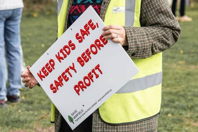 A campaigner holds a sign at the protest.