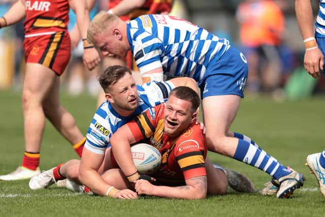 Dewsbury Rams' Harvey Roberts in action with Halifax Panthers' Ben Forster. Photo by John Clifton.