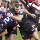 Thornhill Trojans winger Chris Mitchell is stopped in his tracks by some strong Fryston Warriors tackling. Picture: Scott Merrylees