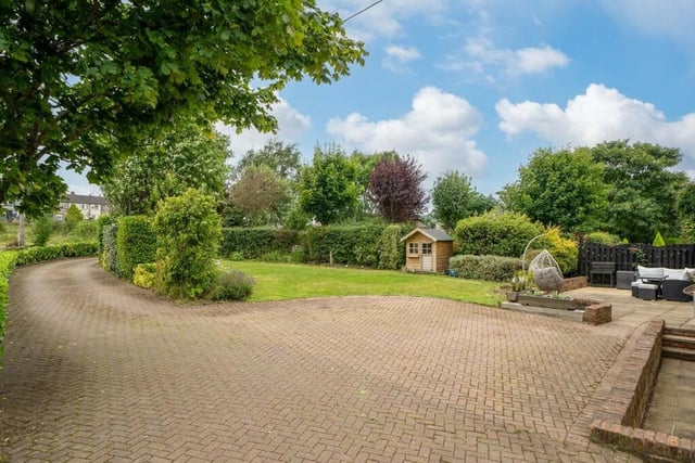 The property has landscaped gardens to the rear with a private sweeping driveway leading to a double garage with electric door. The front of the property has a courtyard area and a large paved garden.