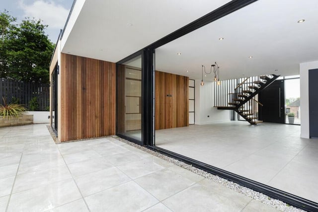 Looking across the rear of the property, with its large glass sliding doors.
