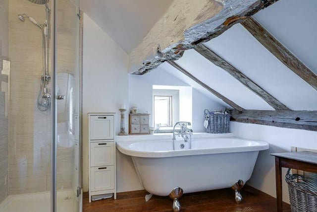 A stylish and functional bathroom with a free standing bath tub and a separate shower unit.