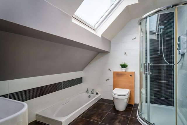 This bathroom has a sunken bath with a separate shower enclosure.