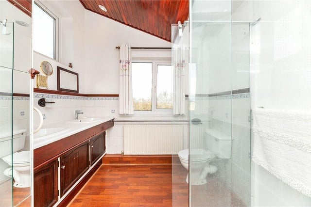 A bathroom featuring twin washbasins within a vanity unit.